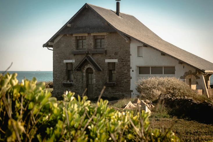 an old brick house with a steeple on the top of it